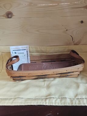Longaberger woven serving basket with tan and dark brown accents
